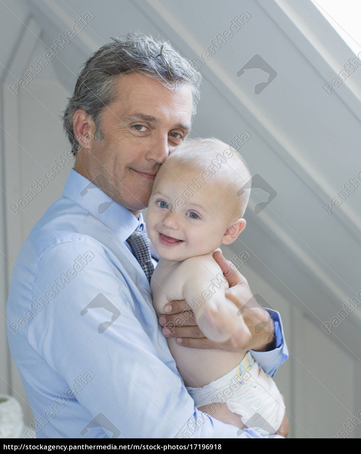 Father Holding Baby Indoors Stockfoto Bildagentur