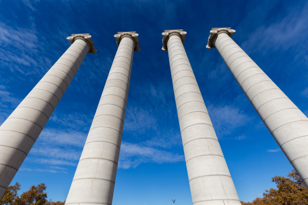 four massive columns blue sky