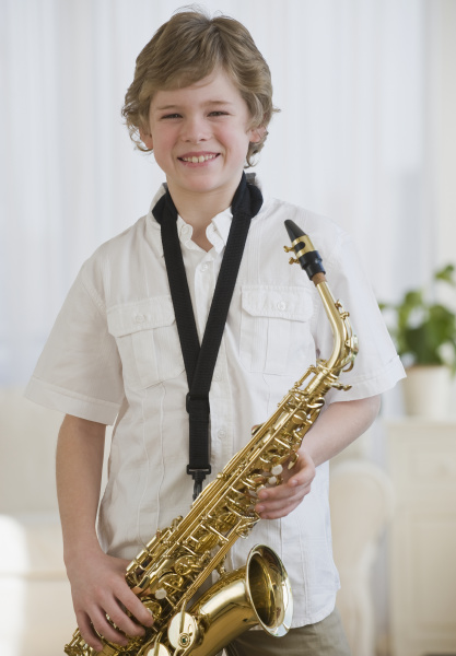 boy holding saxophon
