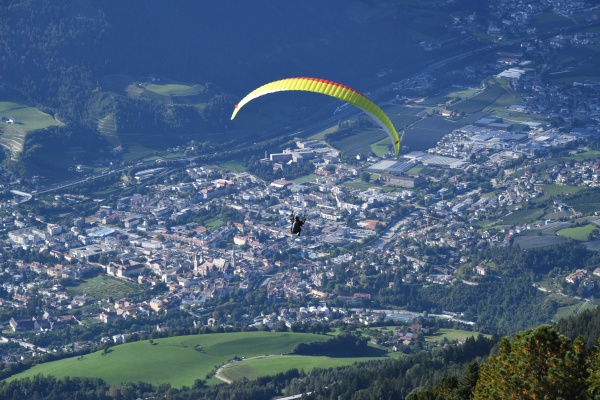 a paraglider over brixen in south