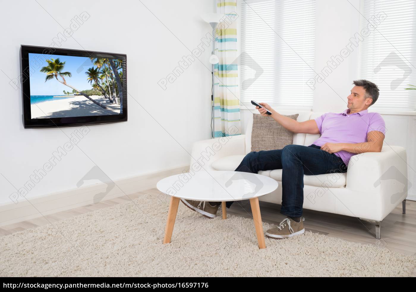 Lizenzfreies Foto 16597176 Mature Man With Remote Control Watching Television