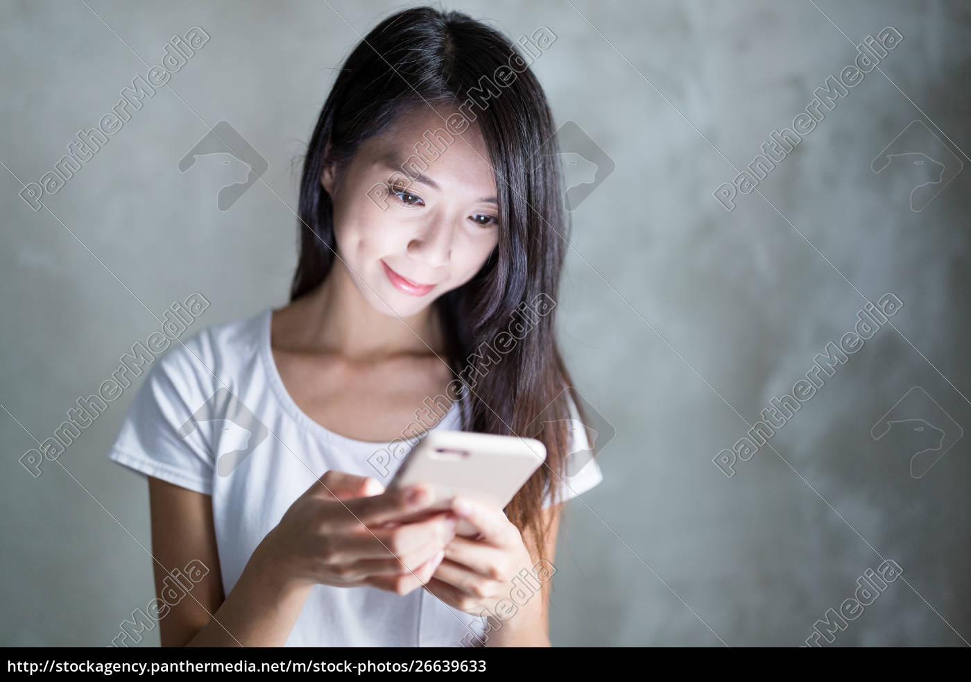 Lizenzfreies Bild 26639633 Young Woman Use Of Mobile Phone Over Grey Background