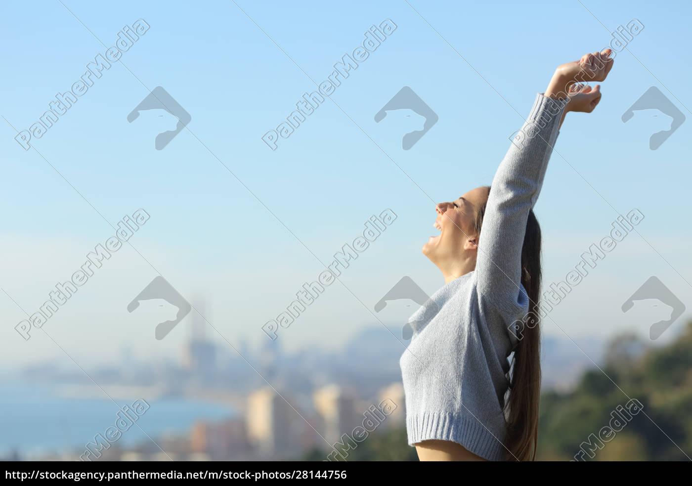 Profile Of Excited Woman Raising Arms In City Outskirts - Lizenzfreies ...